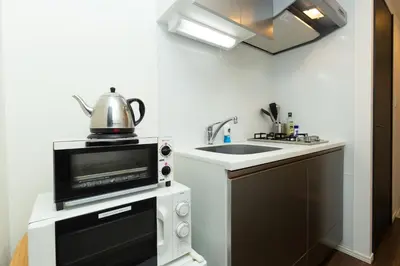 a kitchen with a microwave and a sink at #17 -\u30b7\u30fc\u30d5\u30a9\u30eb\u30e0\u4eac\u6025\u84b2\u7530- Entire Unit in Tokyo