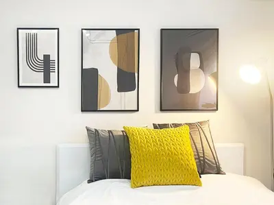 a bedroom with four pictures on the wall above a bed at #17 -\u30b7\u30fc\u30d5\u30a9\u30eb\u30e0\u4eac\u6025\u84b2\u7530- Entire Unit in Tokyo