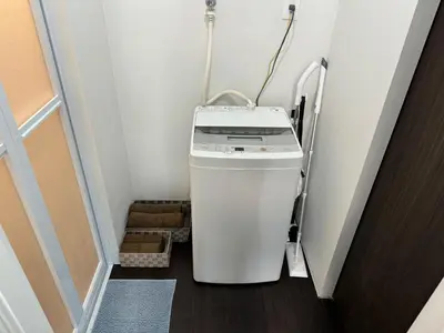 a small refrigerator in a small room with a door at Tokyo Stay Top Ikebukuro #203 in Tokyo