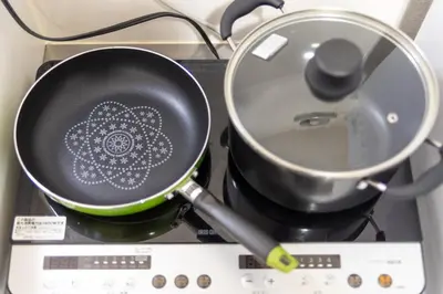 a pan on a stove with a flower on it at Y's INN Nakano 016T in Tokyo