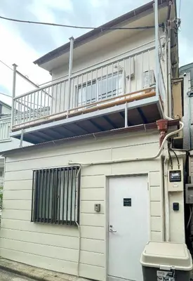 a balcony on the side of a building with a garage at Y's INN Nakano 016T in Tokyo