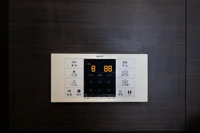 a microwave oven with a clock on the side of it at FINOA Asakusa Sky Terrace in Tokyo