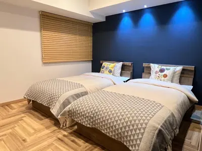 two beds sitting next to each other in a bedroom at Kameido Wisteria Retreat 3 Floor in Tokyo