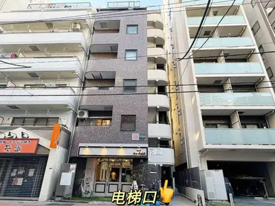 a tall building with a store in front of it at Kameido Wisteria Retreat 3 Floor in Tokyo