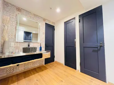 a bathroom with two black doors and a sink at Kameido Wisteria Retreat 3 Floor in Tokyo