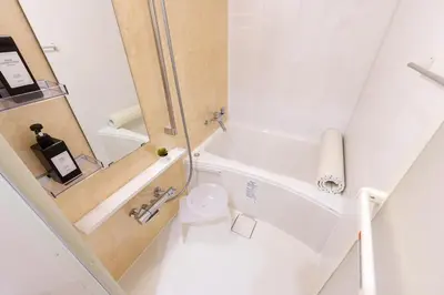 a small bathroom with a toilet and a shower at MINE HOME\u6771\u4e2d\u91ce 116t in Tokyo