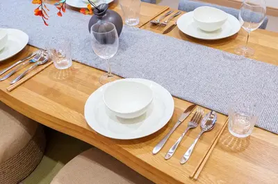 a wooden table with white plates and silverware on it at MINE HOME\u6771\u4e2d\u91ce 116t in Tokyo