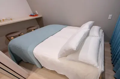 a bedroom with a bed with white sheets and pillows at Y's INN アネックス 012T in Tokyo