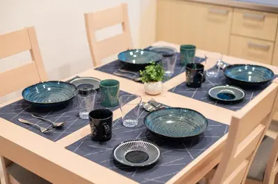 a table with blue plates and glasses on it at Y's INN アネックス 012T in Tokyo