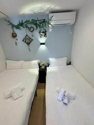 two beds in a room with white sheets at rd\u6c11\u6cca2F in Tokyo