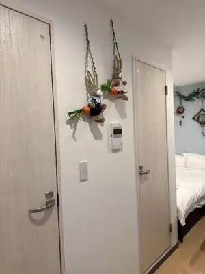 a room with a bed and a door with antlers on the wall at rd\u6c11\u6cca2F in Tokyo