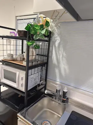 a kitchen counter with a sink and a microwave at rd\u6c11\u6cca3F in Tokyo