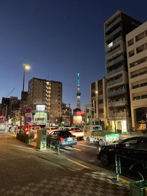 a busy city street at night with cars and buildings at DesignAward,Alphinaud in Tokyo