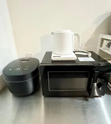 a coffee maker sitting on top of a microwave at DesignAward,Alphinaud in Tokyo