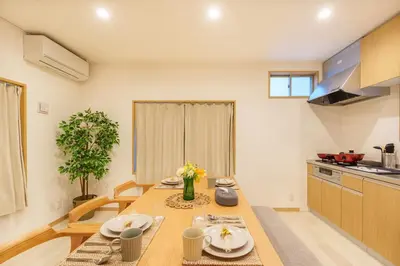 a kitchen with a table with plates and flowers on it at MINE HOME\u6771\u6c60\u888b 117t in Tokyo