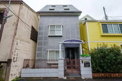 a yellow and grey house with a gate at MINE HOME\u6771\u6c60\u888b 117t in Tokyo