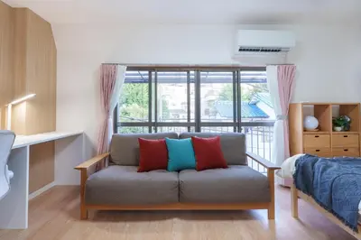 a living room with a couch with four pillows at Y's INN Ikefukuro 109T in Tokyo