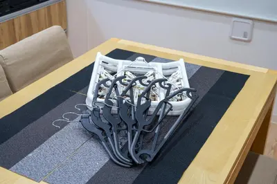 a table with a bunch of tongs on it at Y's INN Ikefukuro 109T in Tokyo