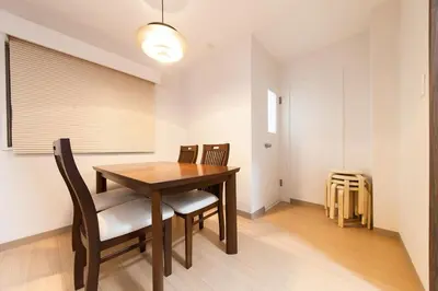 a dining room with a wooden table and chairs at \u697d\u5bbf Itabashi 011T in Tokyo