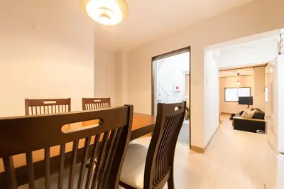 a living room with a dining room table and chairs at \u697d\u5bbf Itabashi 011T in Tokyo