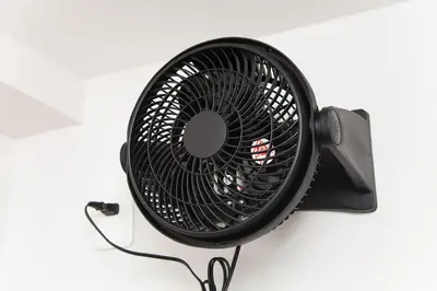 a black fan sitting on top of a wall at \u697d\u5bbf Itabashi 011T in Tokyo