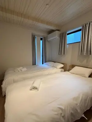 a bedroom with two beds and a window at XQC398 7 mins walk to Asakusa Temple, new house, fully equipped in Tokyo