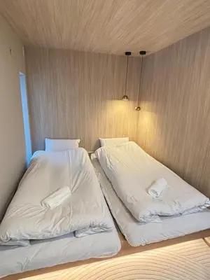 two beds in a room with white sheets at XQC398 7 mins walk to Asakusa Temple, new house, fully equipped in Tokyo