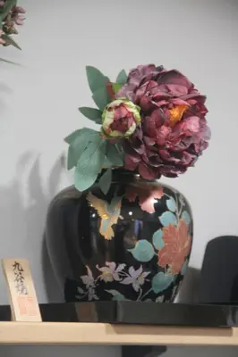 a black vase with flowers in it on a shelf at XQC398 7 mins walk to Asakusa Temple, new house, fully equipped in Tokyo