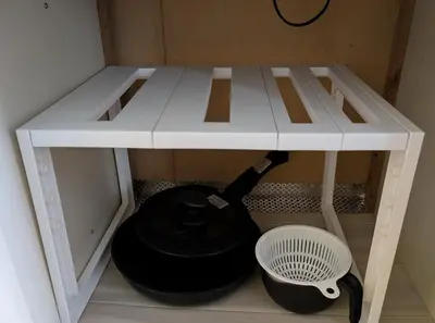 a white table with a wine bottle under it at Nomado Base at YOYOGI in Tokyo