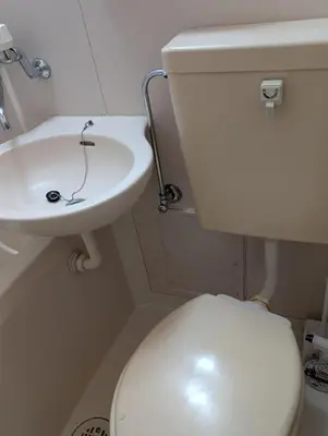 a bathroom with a white toilet and a sink at Nomado Base at YOYOGI in Tokyo