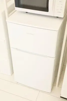 a white dresser with a microwave on top at ALDO INN Toyosu in Tokyo