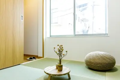 a room with a vase on a table and a chair at \u697d\u5bbf Nishi Shinjuku 017T in Tokyo