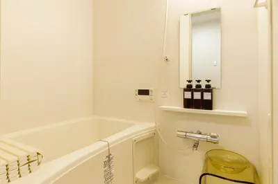 a white bathroom with a tub and a sink at \u697d\u5bbf Nishi Shinjuku 017T in Tokyo