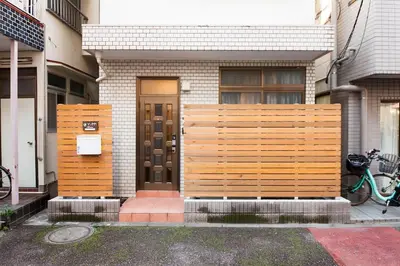 a house with a wooden fence in front of it at Y's INN Koiwa 010T in Tokyo