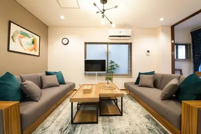 a living room with two couches and a table at Y's INN Koiwa 010T in Tokyo