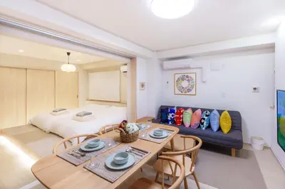 a room with a dining table and a bed at \u697d\u9038\u30b0\u30eb\u30fc\u30d7 \u6c60\u888b\u745e\u6708\u82d11F 111Ta in Tokyo