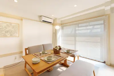 a dining room with a wooden table and chairs at \u697d\u9038\u30b0\u30eb\u30fc\u30d7 \u6c60\u888b\u745e\u6708\u82d12F 111Tb in Tokyo