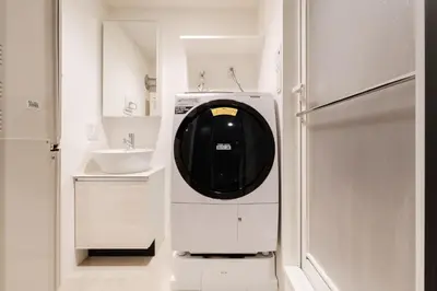 a washing machine in a kitchen with a sink at T r u s t V a l u e Kuramae in Tokyo