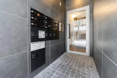 a bathroom with a wall with wine bottles at T r u s t V a l u e Kuramae in Tokyo
