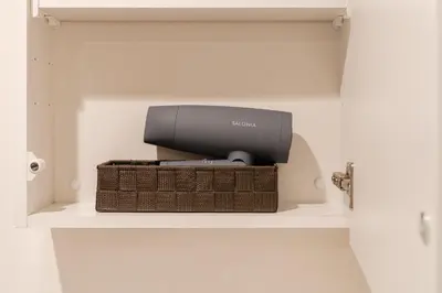 a television sitting on a shelf in a closet at T r u s t V a l u e Kuramae in Tokyo