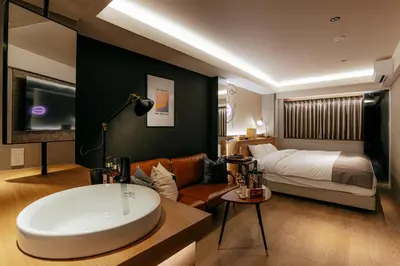 a hotel room with a bath tub and a bed at Hotel The Loop in Tokyo