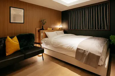 a bedroom with a large bed and a couch at Hotel The Loop in Tokyo