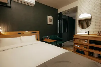 a bedroom with a large bed and a bathroom at Hotel The Loop in Tokyo
