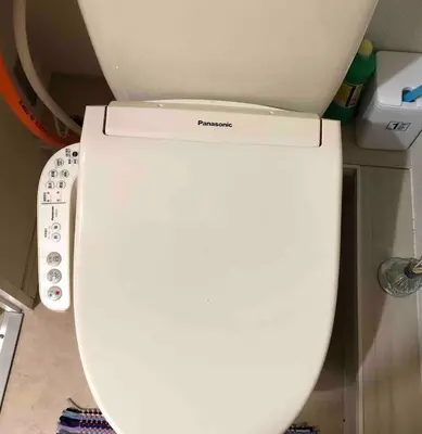 a white toilet with the lid up in a bathroom at Shinjuku 105 in Tokyo