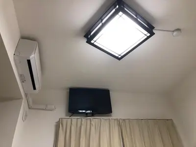 a room with a tv and a window in a room at Shinjuku 105 in Tokyo