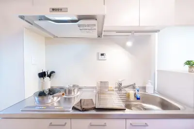 a kitchen with a sink and a counter top at \u697d\u9038\u30b0\u30eb\u30fc\u30d7 \u6c60\u888b\u745e\u6708\u82d13F 111Tc in Tokyo