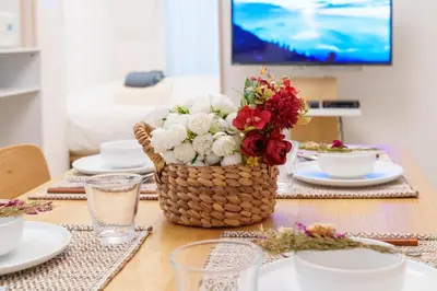 a table with a centerpiece of flowers in a basket at \u697d\u9038\u30b0\u30eb\u30fc\u30d7 \u6c60\u888b\u745e\u6708\u82d13F 111Tc in Tokyo