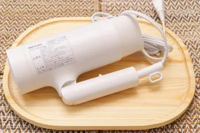 a white blow dryer on a wooden cutting board at \u697d\u9038\u30b0\u30eb\u30fc\u30d7 \u6c60\u888b\u745e\u6708\u82d13F 111Tc in Tokyo