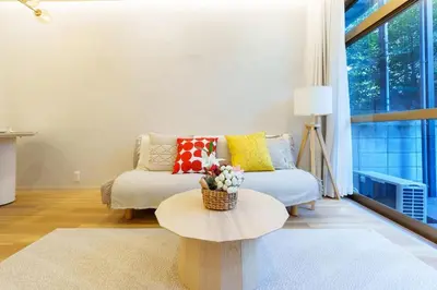 a living room with a couch and a table at \u697d\u9038\u30b0\u30eb\u30fc\u30d7 \u9ad8\u7530\u99ac\u5834 114t in Tokyo