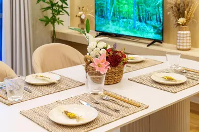a table with plates and flowers on top of it at \u697d\u9038\u30b0\u30eb\u30fc\u30d7 \u9ad8\u7530\u99ac\u5834 114t in Tokyo